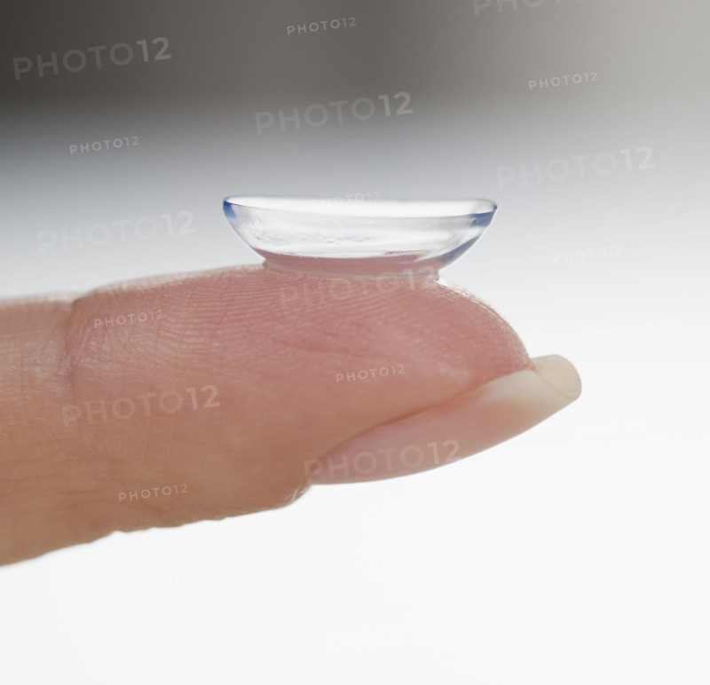 Closeup of finger with contact lens.