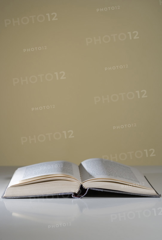 An open book lying on a table.