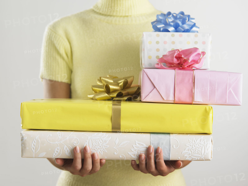 Woman holding pile of presents.