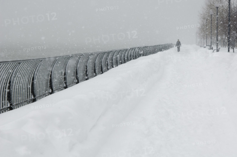Person walking outdoors in a snowstorm.