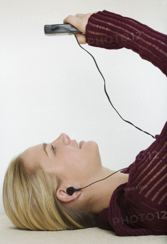Woman listening to a portable music player.
