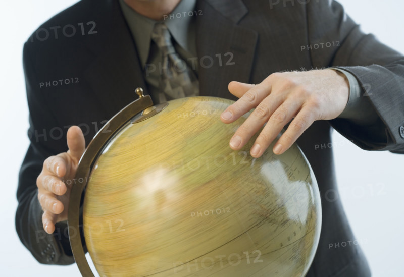 Man spinning a globe.
