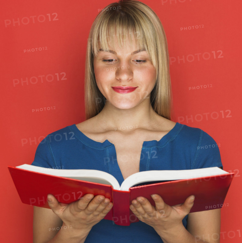 Studio shot of woman reading a book.