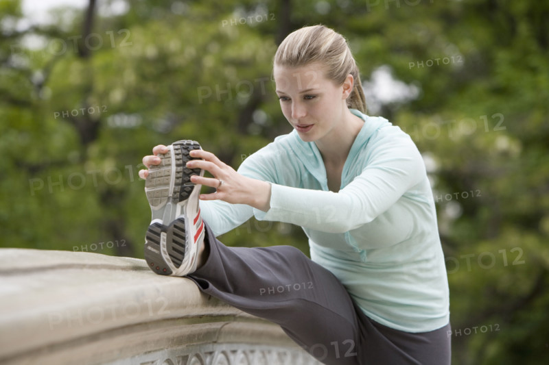 Woman stretching in park.