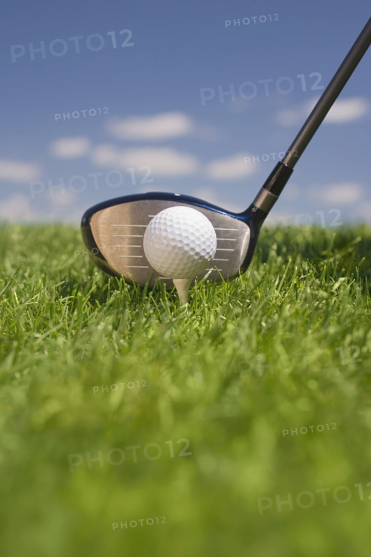 Closeup of golf ball teed up for play.