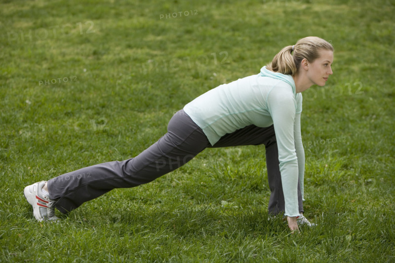 Woman stretching in park.
