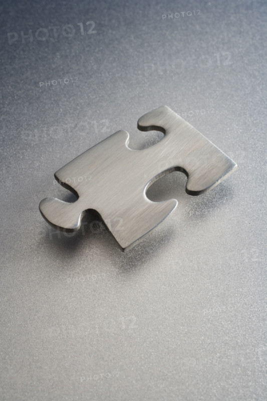 Metallic jigsaw puzzle piece.