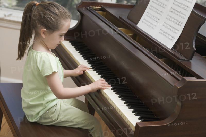 Young girl playing piano.