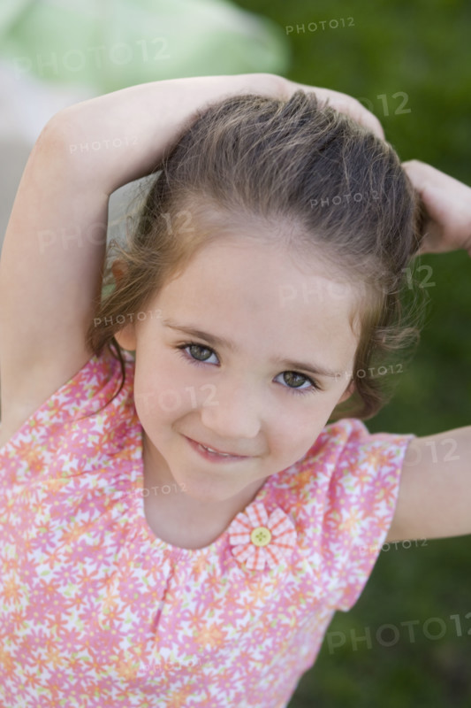 Young girl smiling outdoors.