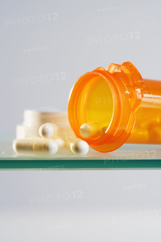 Close up of pill bottle with pills spilled out.