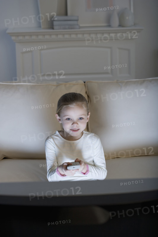 Young girl watching television .