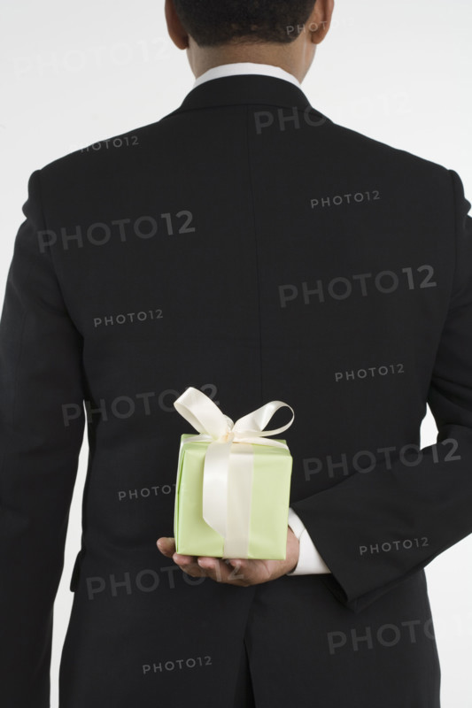 Man holding gift against his back.