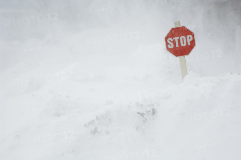 Stop sign in snow bank.
