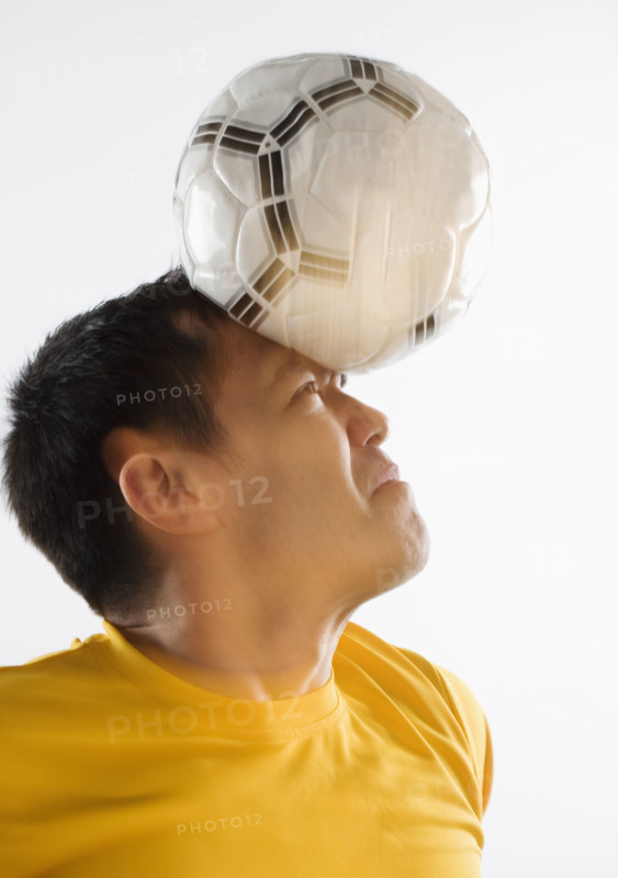 Man playing with soccer ball.