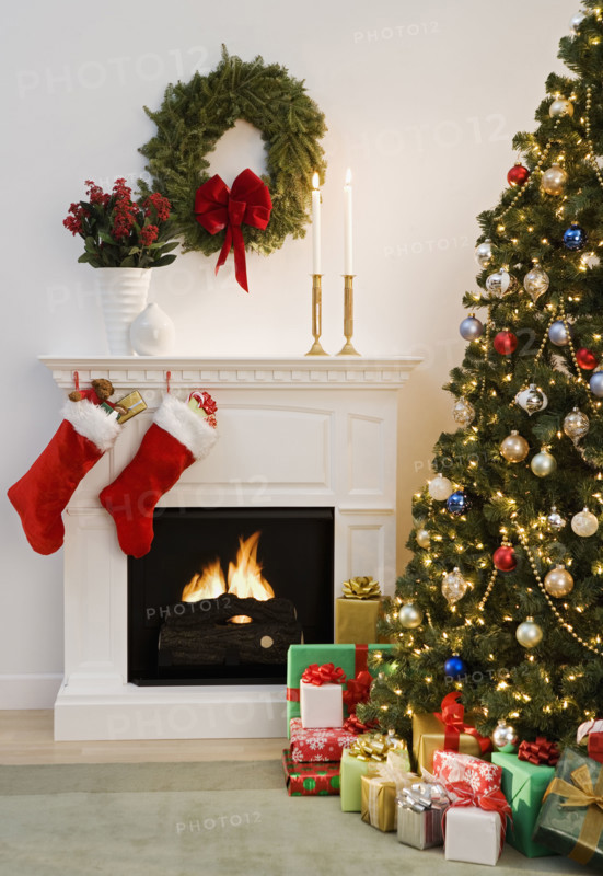 Christmas tree with presents and fireplace with stockings.