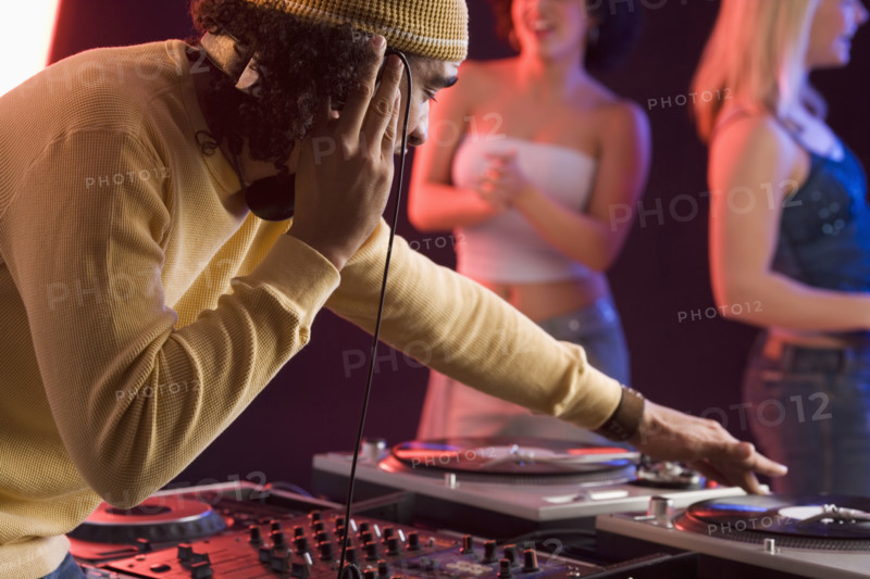 Young man playing music at a dance club.