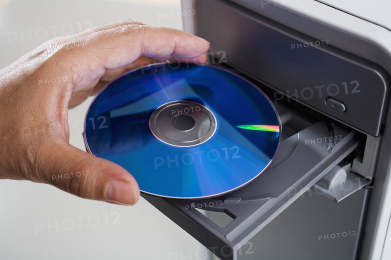 Close up of cd being inserted in to cd rom drive.