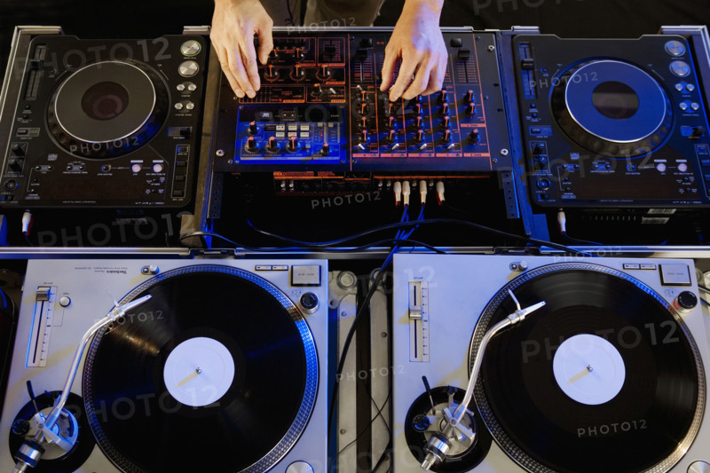 Person mixing music in a nightclub.