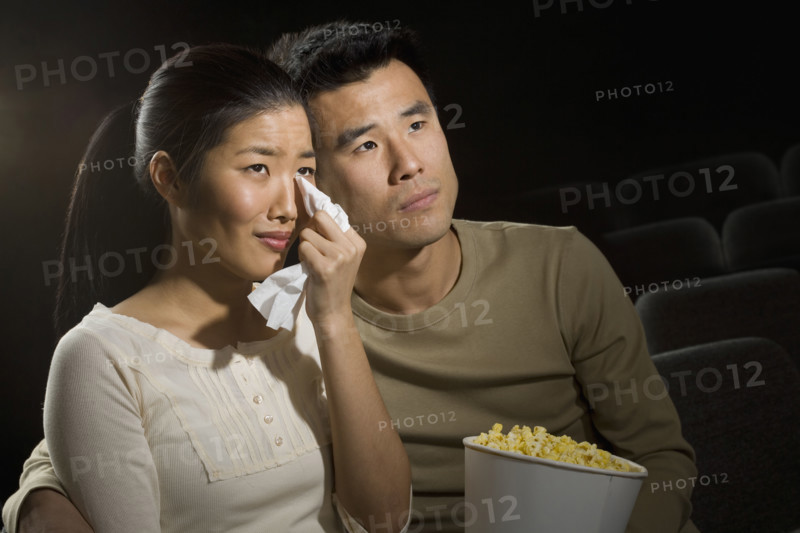 Couple watching a sad movie.