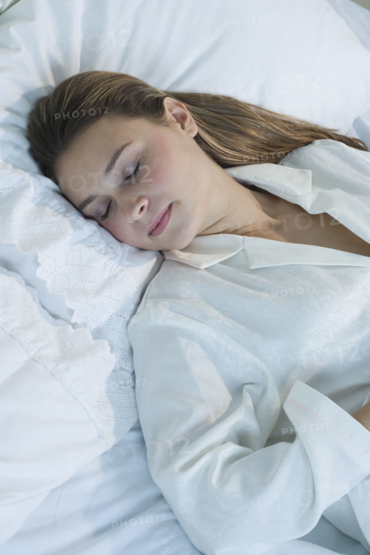 Woman sleeping in bed.