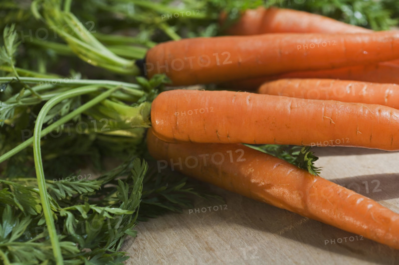 Close up of carrots with the greens attached.