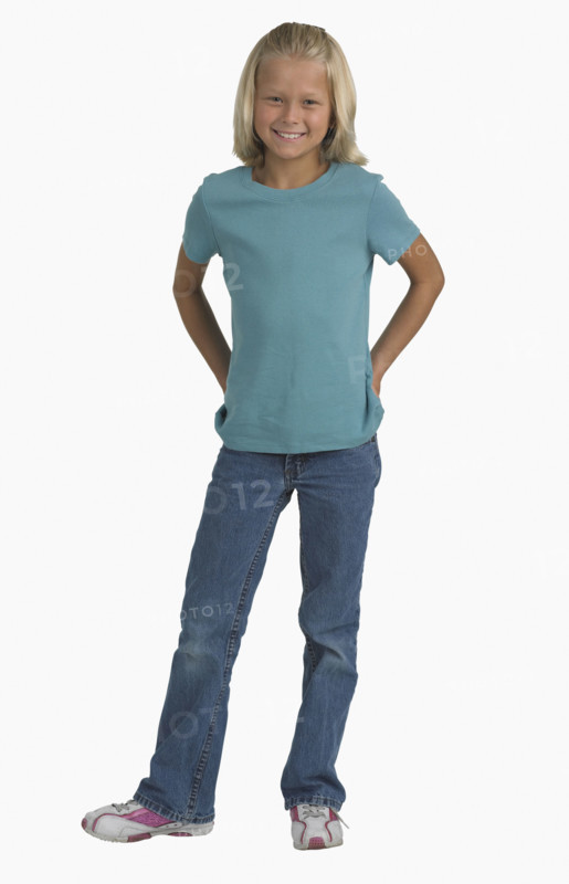 Studio shot of girl with hands in back pockets.