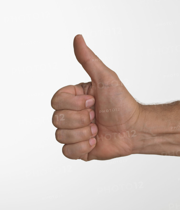 Studio shot of man's hand giving thumbs up.