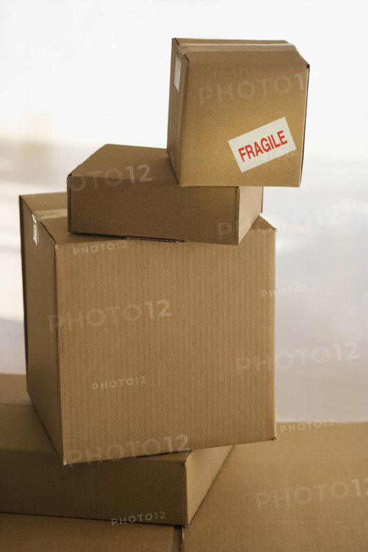 Shipping box with fragile sticker on top of stack.