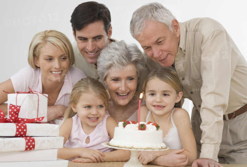 Girl celebrating birthday with family.