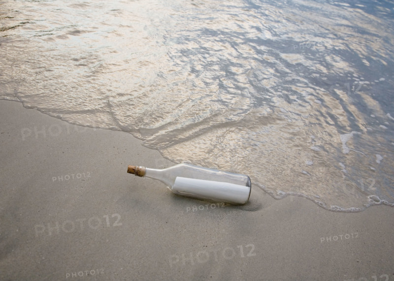 Message in bottle on beach.