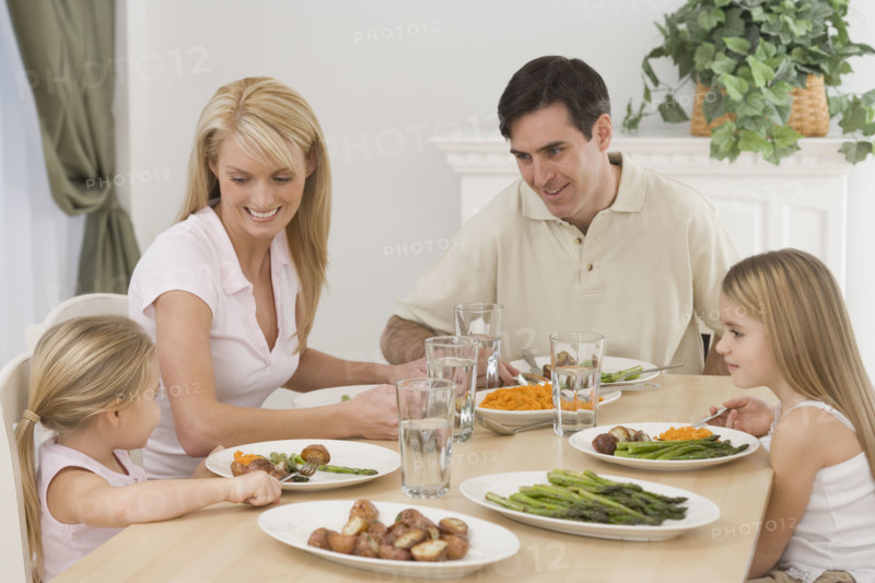 Family eating at dinner table.