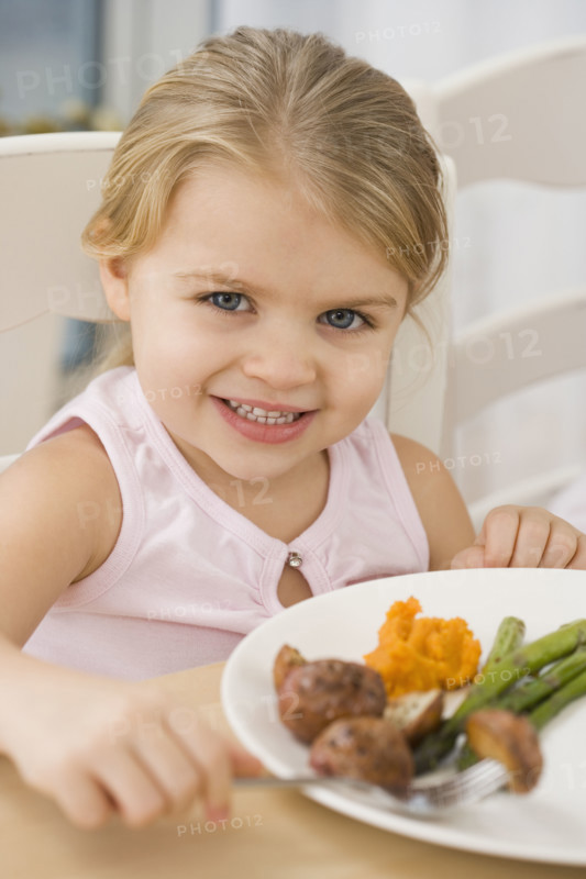 Portrait of girl at dinner table.