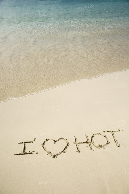 I Love Hot written in sand.