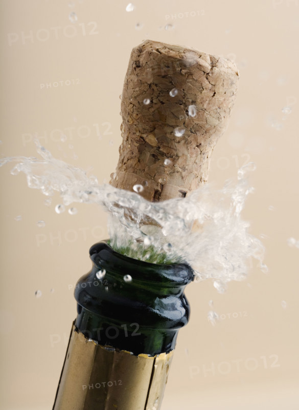 Close up of champagne cork popping.