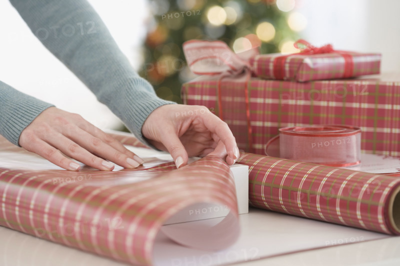 Woman wrapping Christmas gifts.