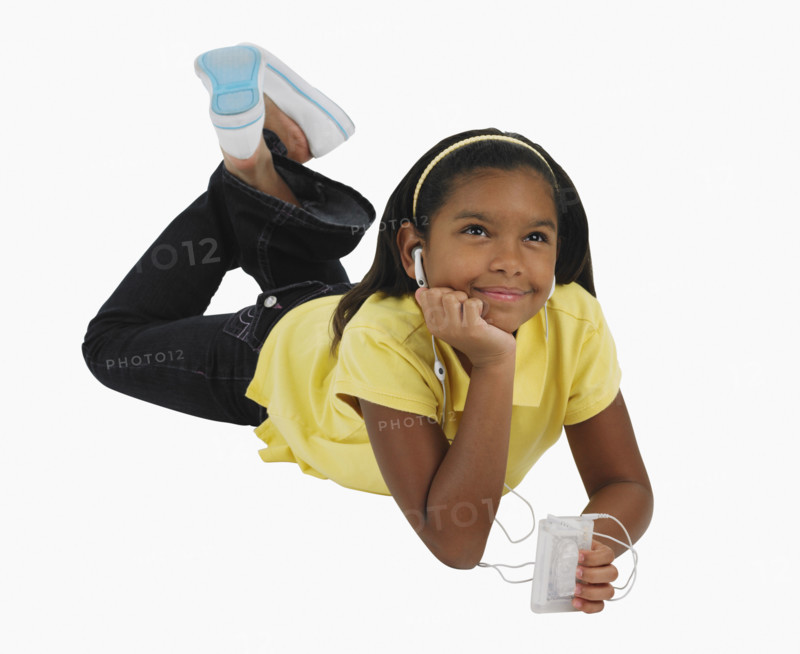 Studio shot of girl listening to mp3 player.