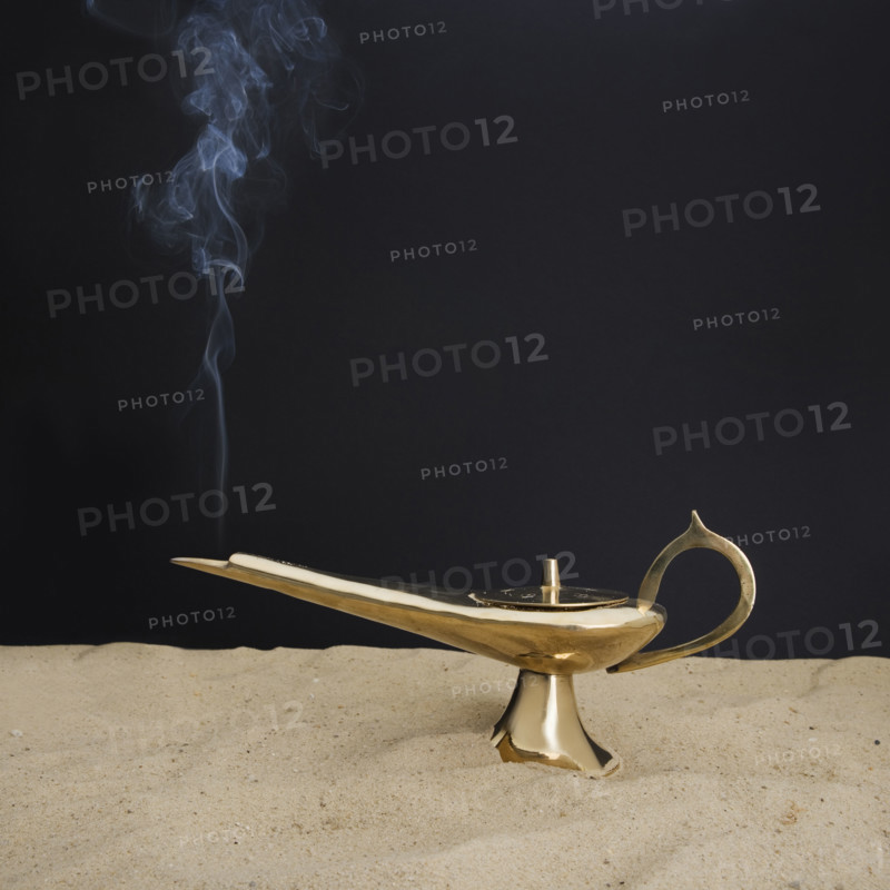 Close up of incense burner on sand.