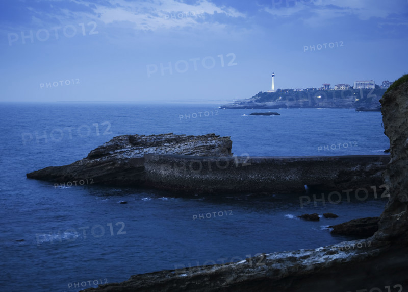 Scenic view of cliffs and lighthouse, Biarritz, France.