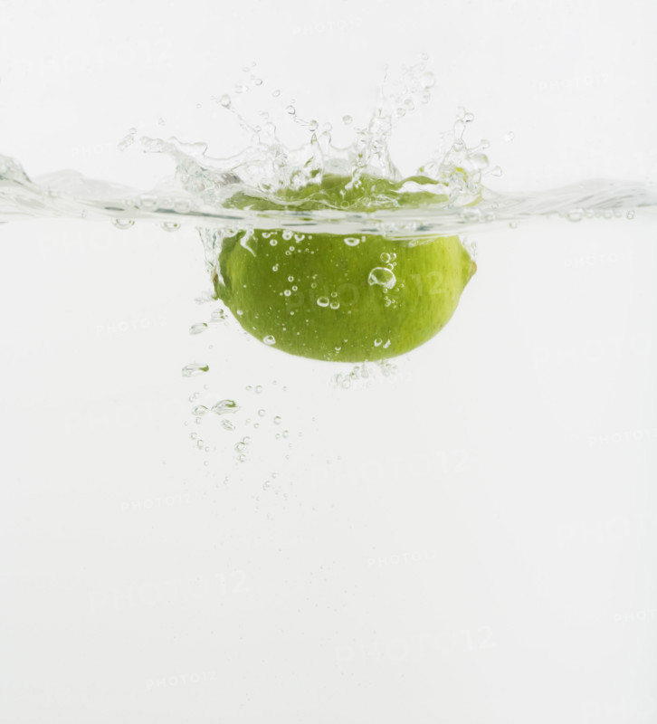 Citrus fruit dropped into water.