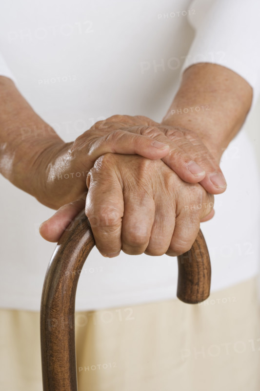 Close up of senior's hands on cane.