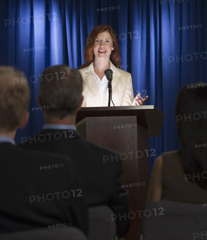 Businesswoman speaking at podium.