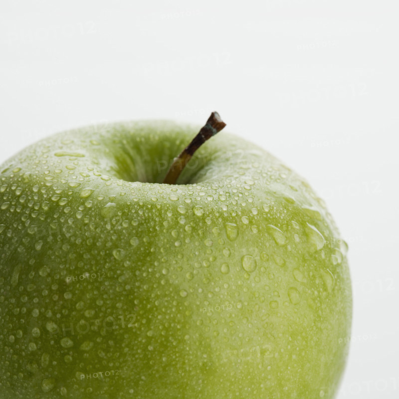 Close up of apple with water droplets.