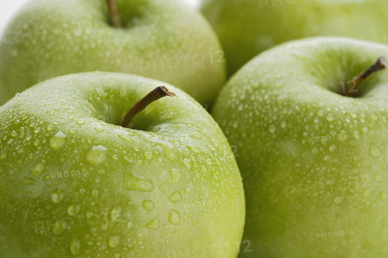 Close up of apples with water droplets.