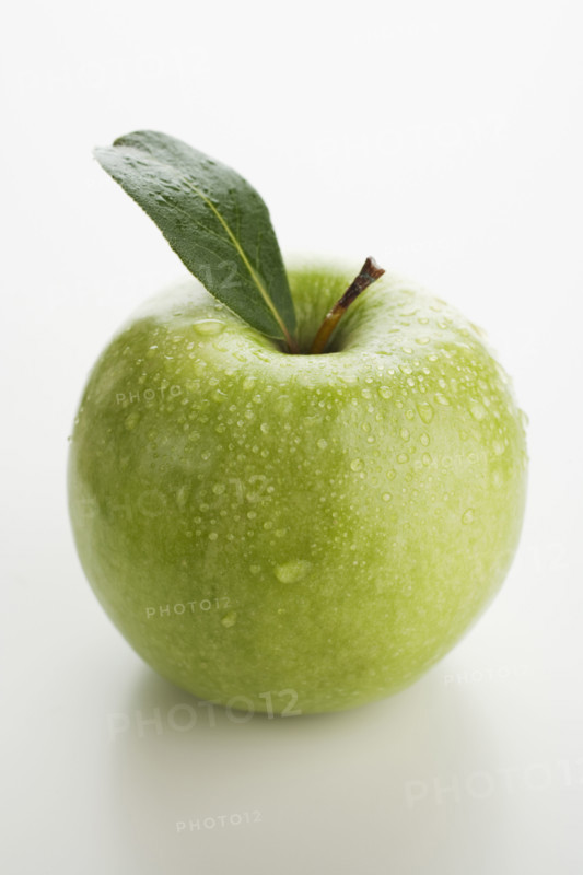 Close up of apple with water droplets.