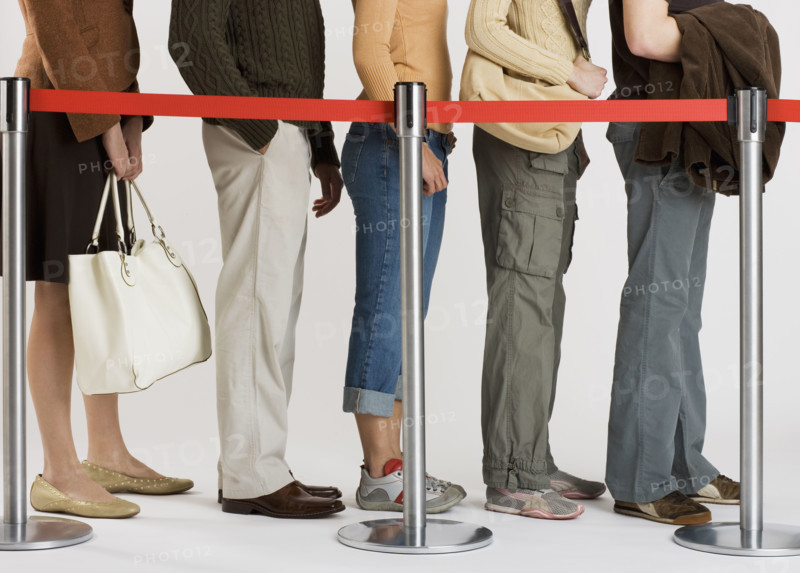 Group of people standing in line.