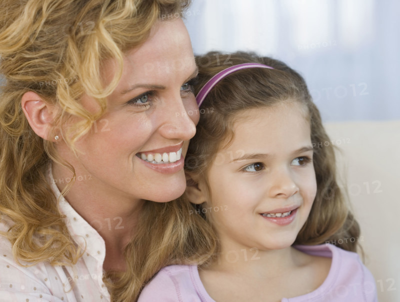Close up of mother and daughter smiling.