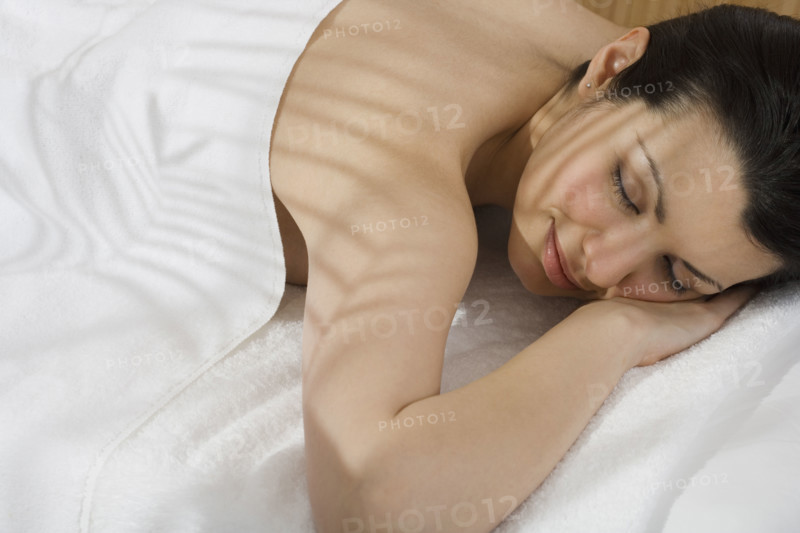 Woman laying on spa table.
