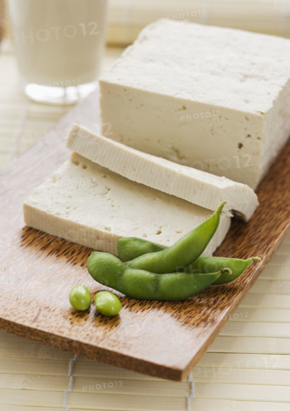 Soybeans and sliced tofu on table.