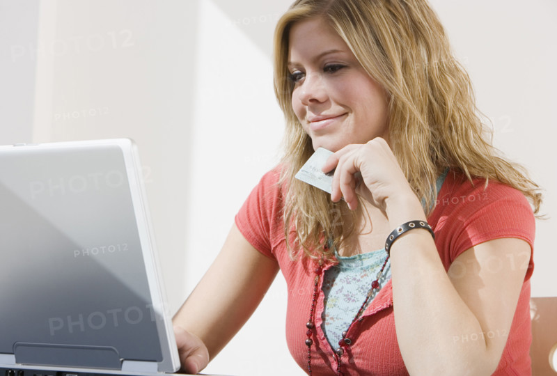 Woman shopping online with laptop.
