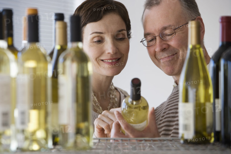 Couple looking at wine in store.